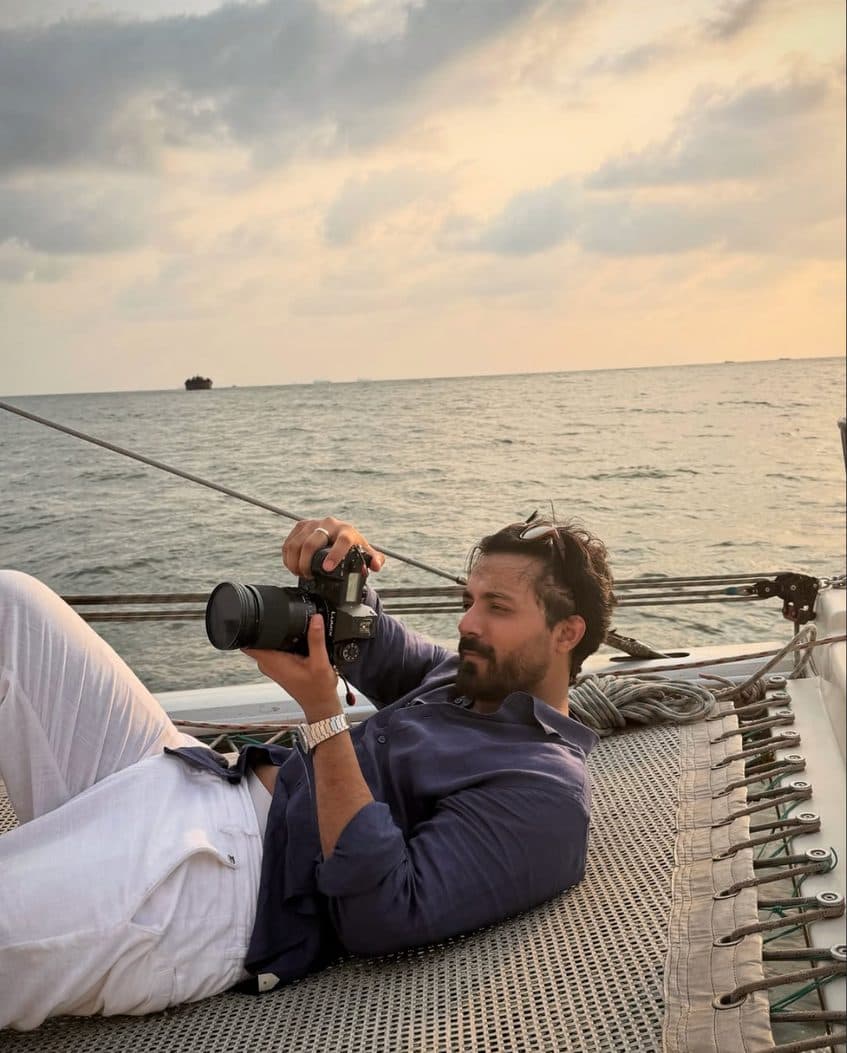 Ashwani Verma photographing from the deck of a boat at sunset